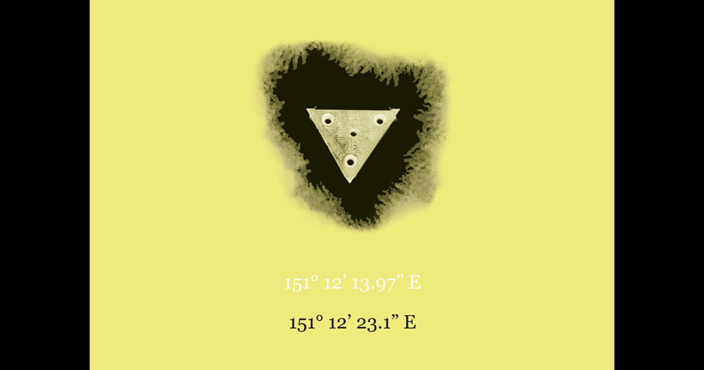 Triangular shape with 4 drill holes in the centre of the image surrounded by black shadows on a yellow background